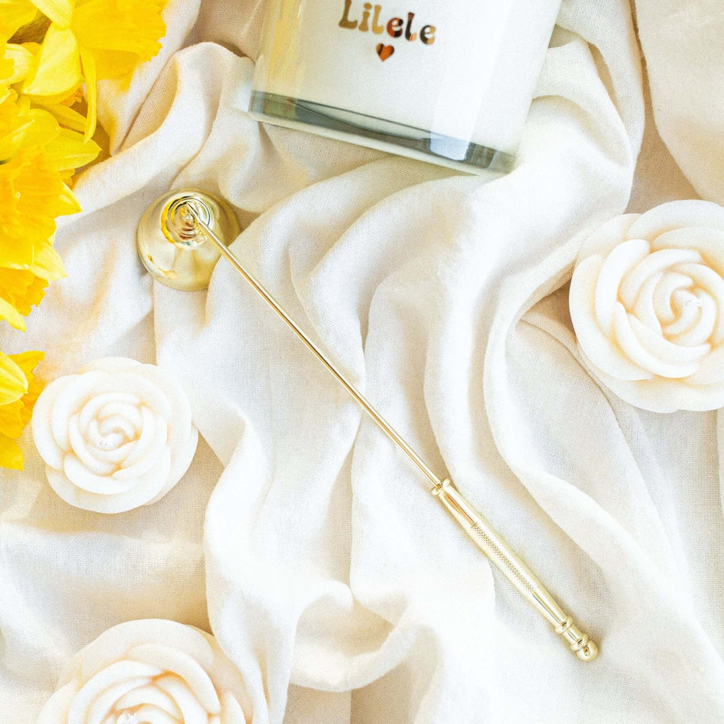 Elegant gold candle snuffer with long handle and bell-shaped end