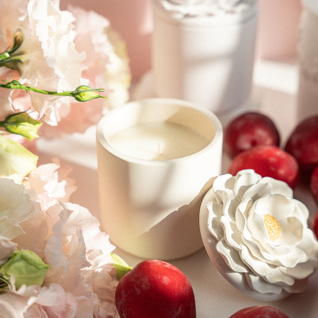 Beige floral Camelia jar filled with Cashmere Plum soy candle