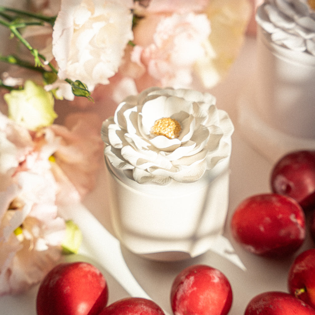 Handmade scented candle with fruity plum and warm vanilla notes