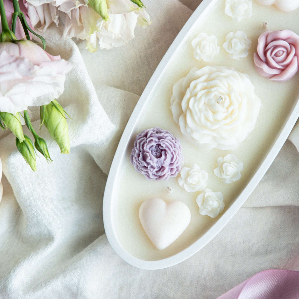 Gift soy wax candle with floral embeds, displayed in elegant gypsum jar