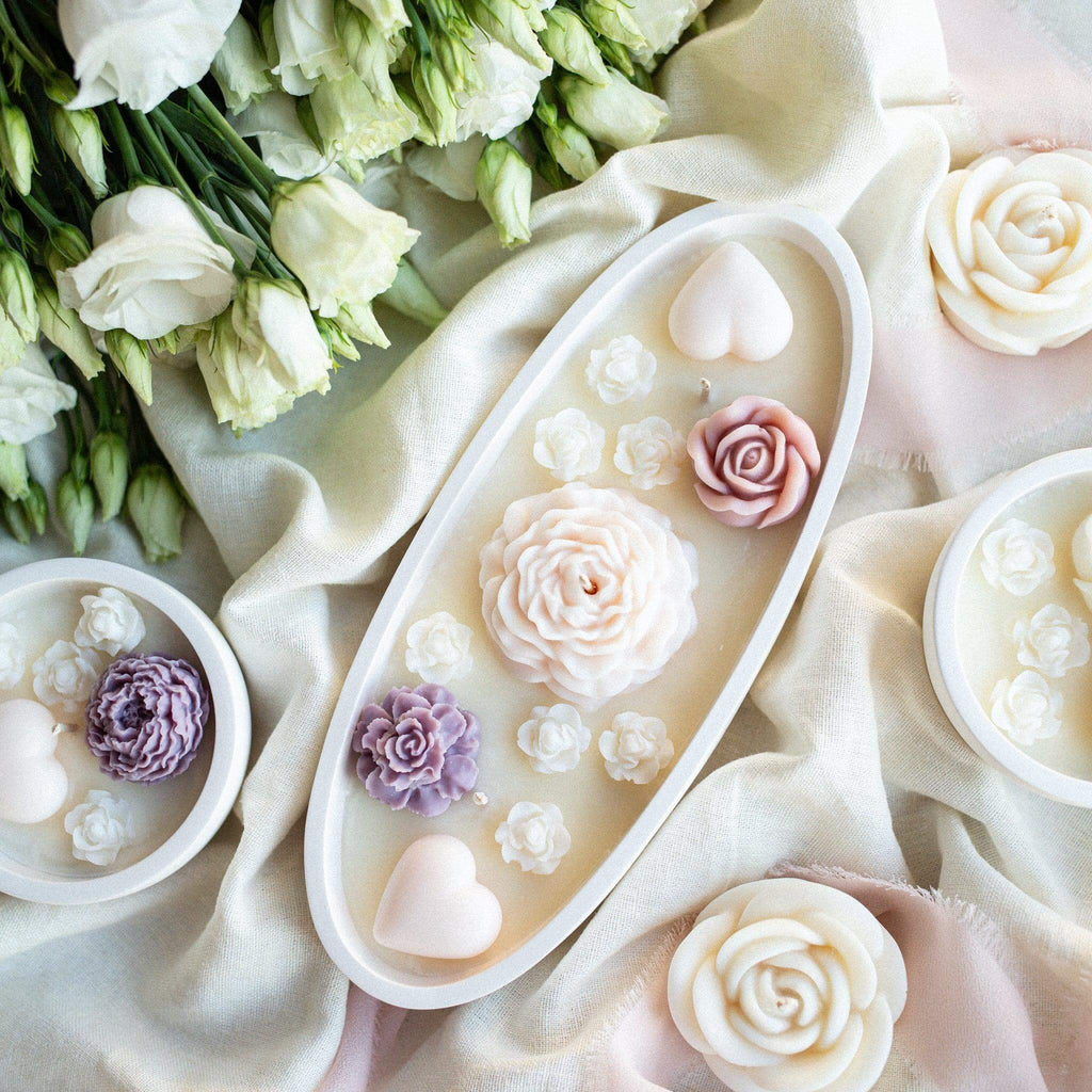 Luxury handcrafted soy wax candle with detailed flower embeds in white jar